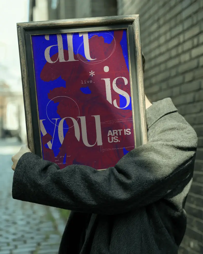 Poster Frame Held In Front Of Face On Street With Sunlight And Brick Wall