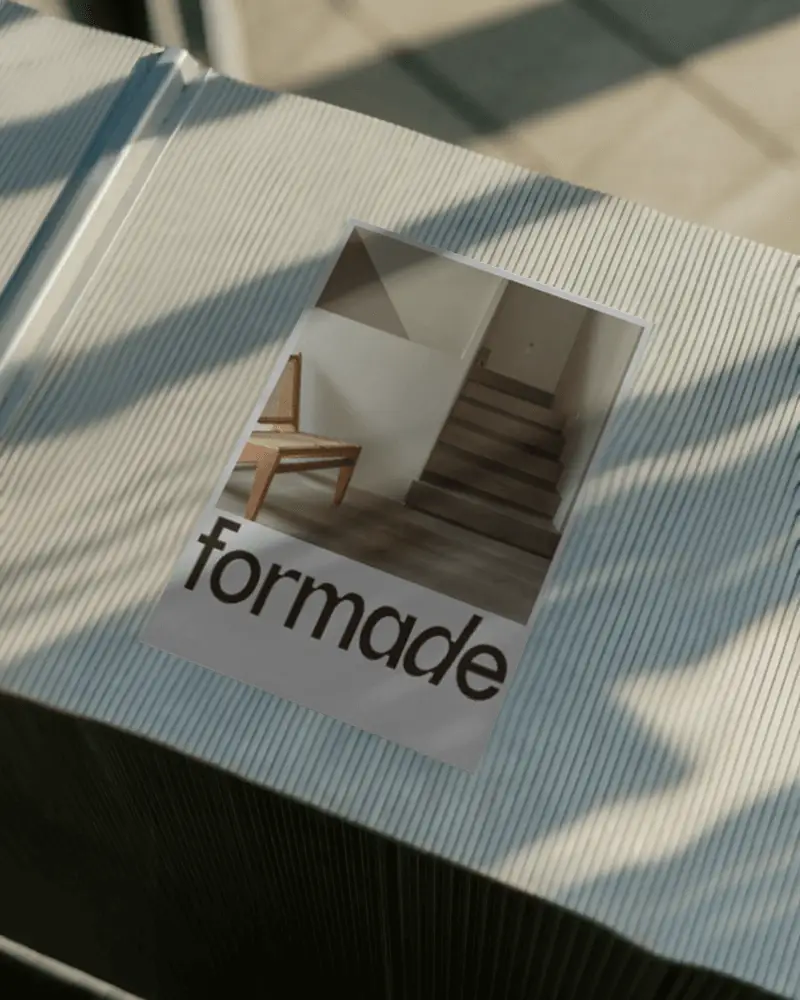 Stylish Blank Poster Display On Ridged Textured Table With Soft Sunlight Effects