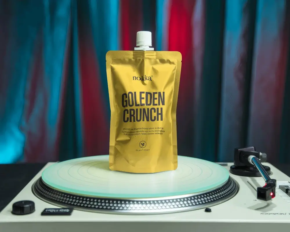 Glossy Spouted Pouch Mockup On Vinyl Turntable Dramatic Blue Red Lighting Edgy Music Themed Scene