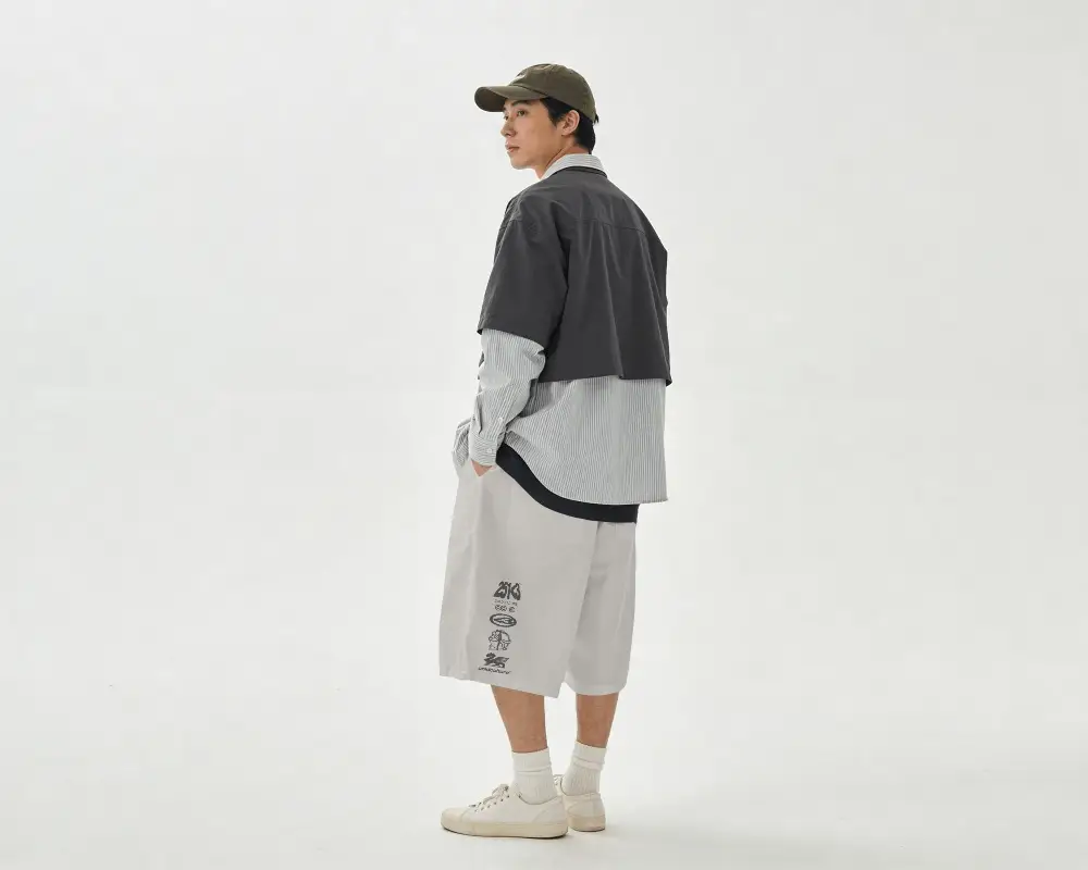 Rear View Shorts Mockup Male Model Looking Back Over Shoulder Clean Studio Background Soft Lighting