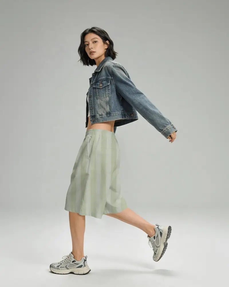 Walking Motion Shorts Mockup Female Model Mid Step Side View Clean Studio Background Soft Lighting
