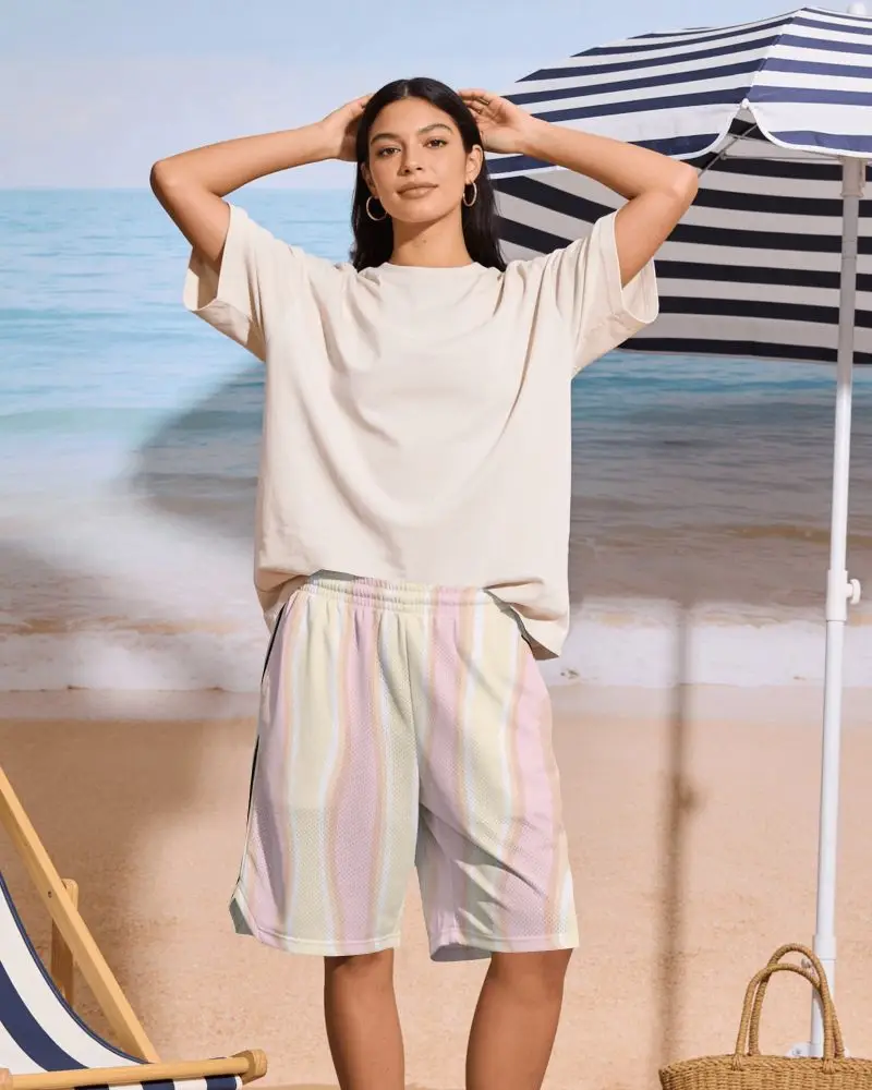 Beach Vacation Shorts Mockup Female Model Standing Near Seaside Umbrella In Relaxed Summer