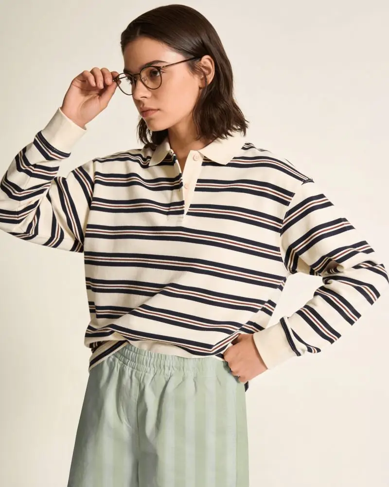 Minimal Studio Shorts Mockup Female Model Wearing Striped Polo Top With Glasses And Relaxed Fit