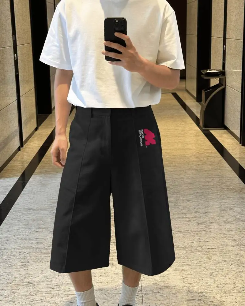 Mirror Selfie Shorts Mockup Model Wearing Wide Leg Bottoms With Oversized White T Shirt In Hallway