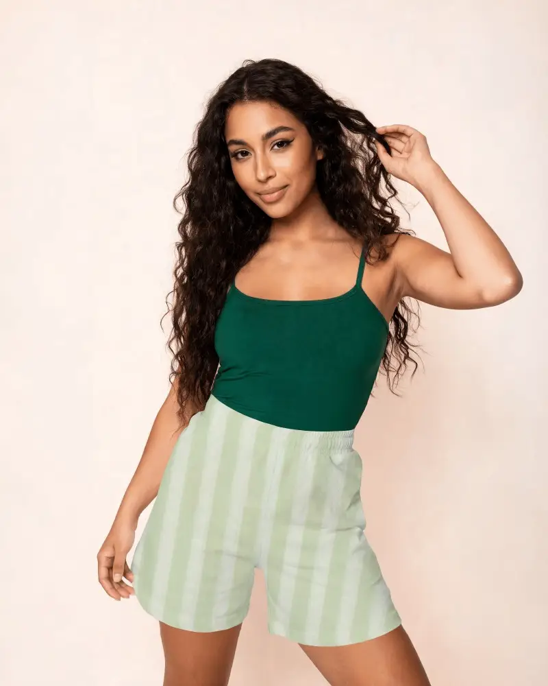 Womens Shorts Mockup On Female Model With Curly Hair And Minimal Studio Background