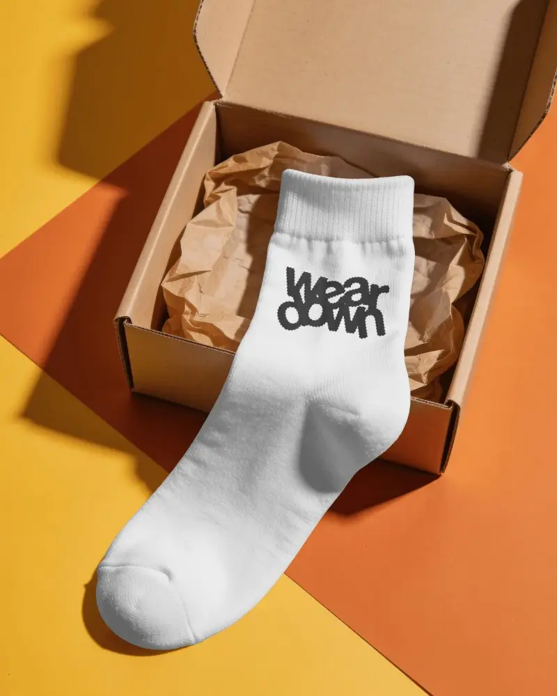 Open Box Socks Mockup With Single Crew Sock Draped Over Packaging And Crumpled Tissue Paper