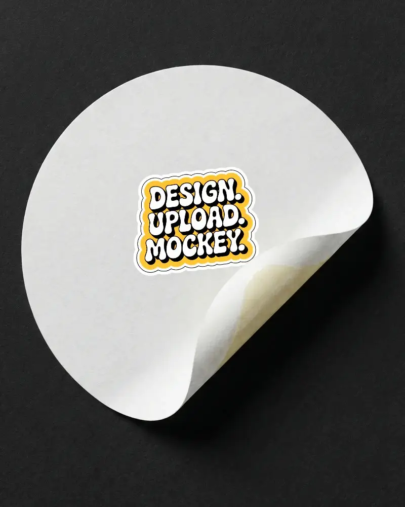 Isolated Round Adhesive Sticker Mockup With Curled Edge On Dark Surface For Showcase