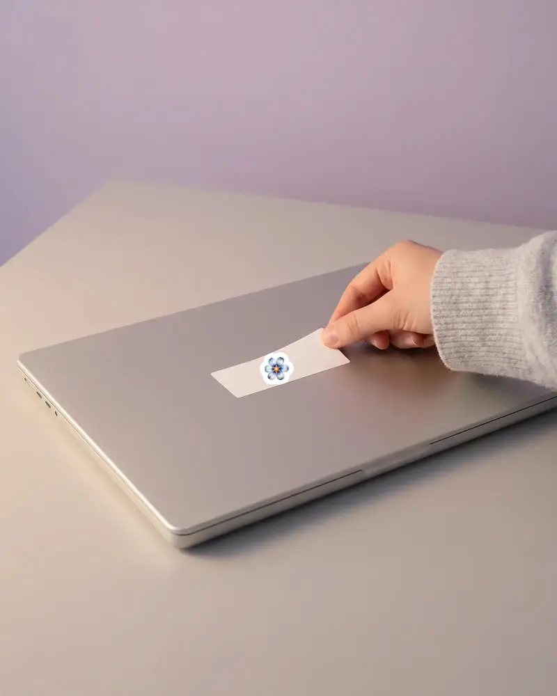 Realistic Rectangle Sticker Mockup Hand Removing From Closed Laptop Flat Surface