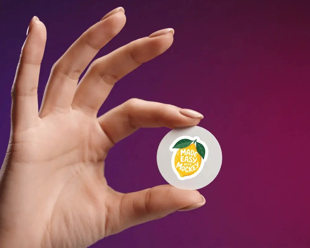 Hand Holding Small Round Sticker Mockup For Custom Logo Or Design Display