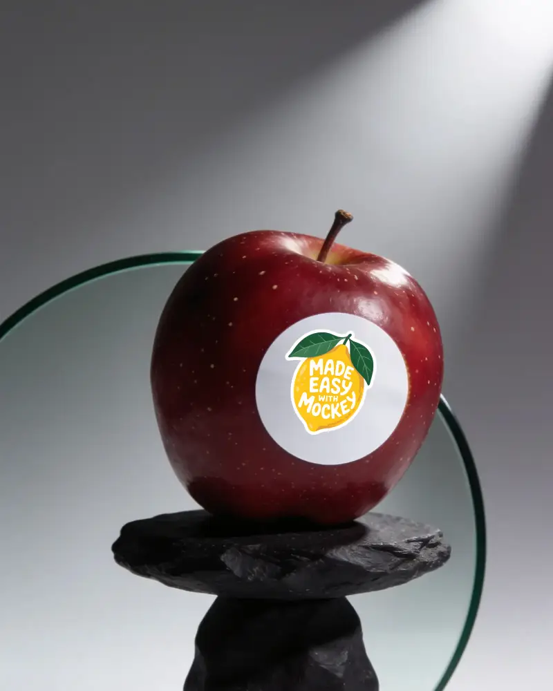 Realistic Circle Sticker Mockup On Apple Fruit Isolated With Reflective Background Style