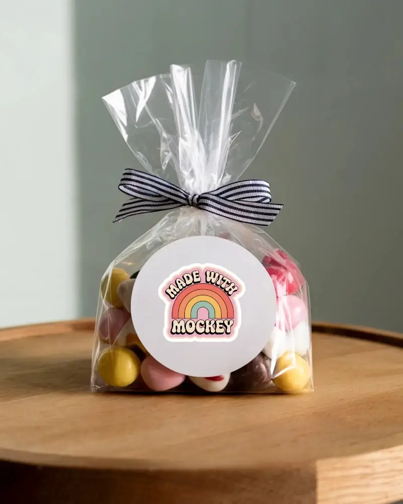 Blank Round Sticker Mockup On Transparent Bag Gift Packaging With Striped Ribbon Tie