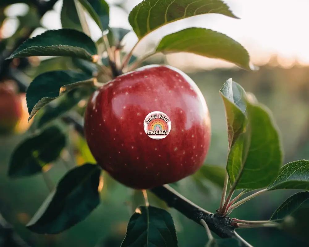 Closeup Sticker Mockup On Apple With Leaves And Natural Sunlight Background