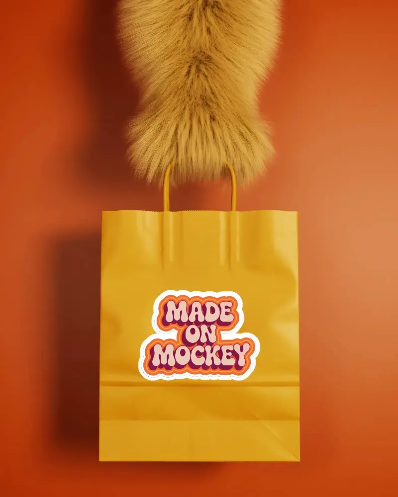 Fluffy Animal Paw Holding Paper Shopping Bag On Solid Background  With Sticker Mockup