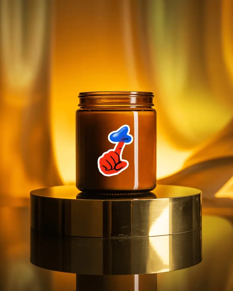Sticker Mockups Amber Glass Jar On Golden Metal Podium With Warm Luxury Backdrop