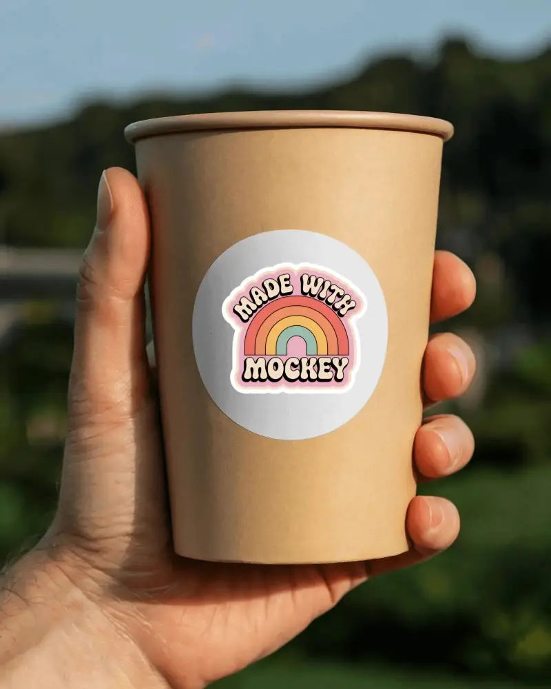 Hand Holding Paper Coffee Cup With Round Blank Sticker Mockup For Custom Branding Promotion