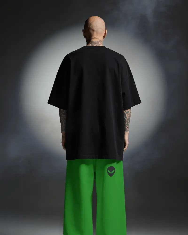 Back View Sweatpants Mockup Male Model Standing In Moody Studio With Tee And Spotlight Background