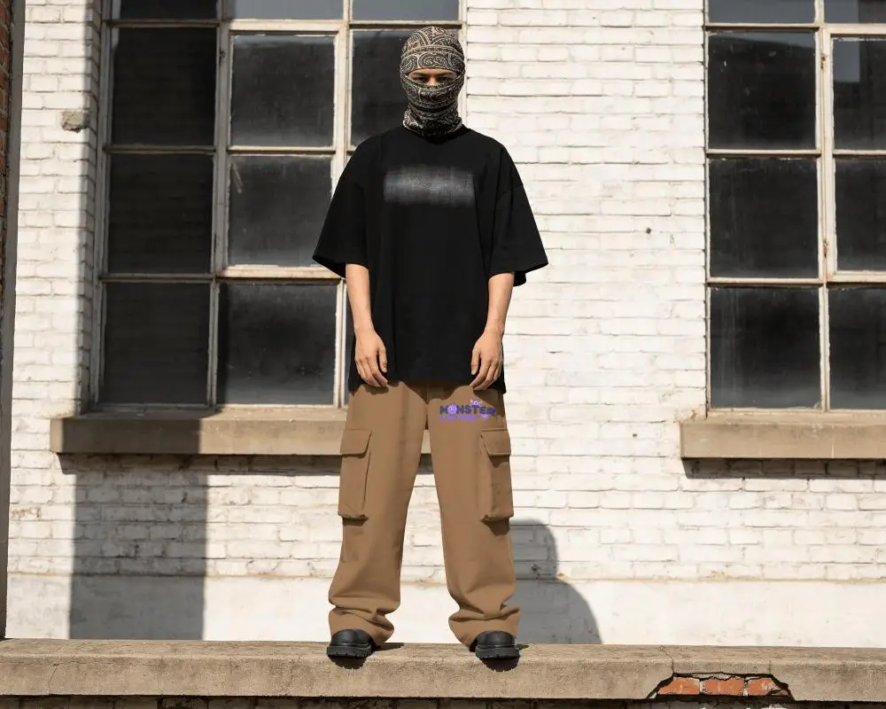 Industrial Streetwear Sweatpants Mockup Male Model Standing On Concrete Ledge With White Brick Wall
