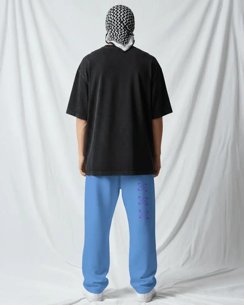 Back View Sweatpants Mockup Male Model Wearing Relaxed Bottom With Oversized Tee And Draped Studio