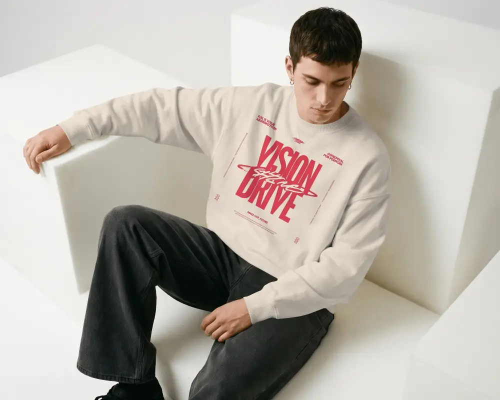 Oversized Sweatshirt Mockup Male Model Seated On White Geometric Blocks In Minimal Studio