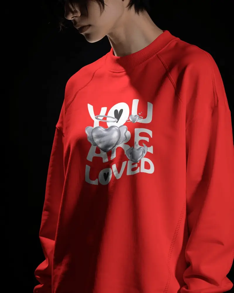 Dramatic Sweatshirt Mockup Female Model Under Hard Spotlight Against Black Background