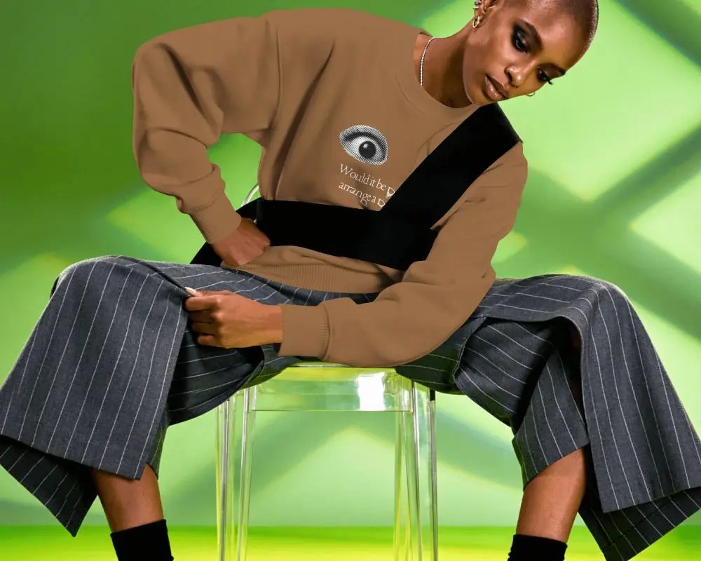 Editorial Sweatshirt Mockup Female Model Seated On Transparent Chair In Vibrant Green Studio