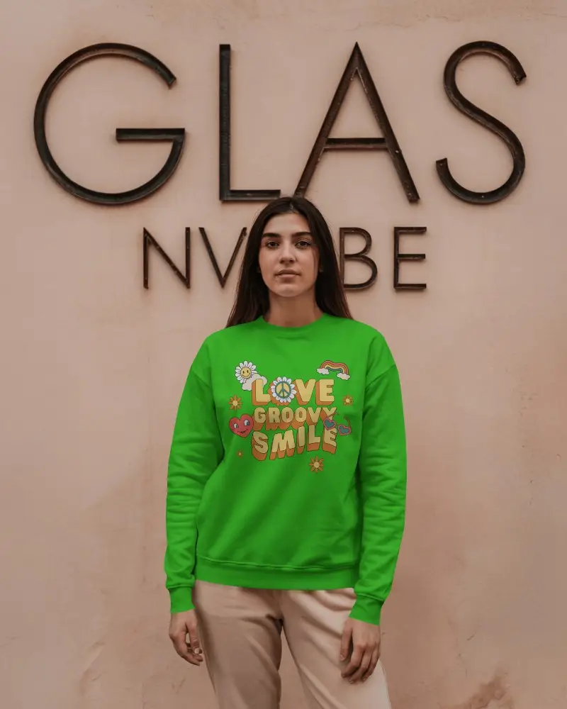 Urban Chic Sweatshirt Mockup Female Model In Front Of Textured Peach Wall Modern Signage Background Neutral Tones Clean And Composed Style