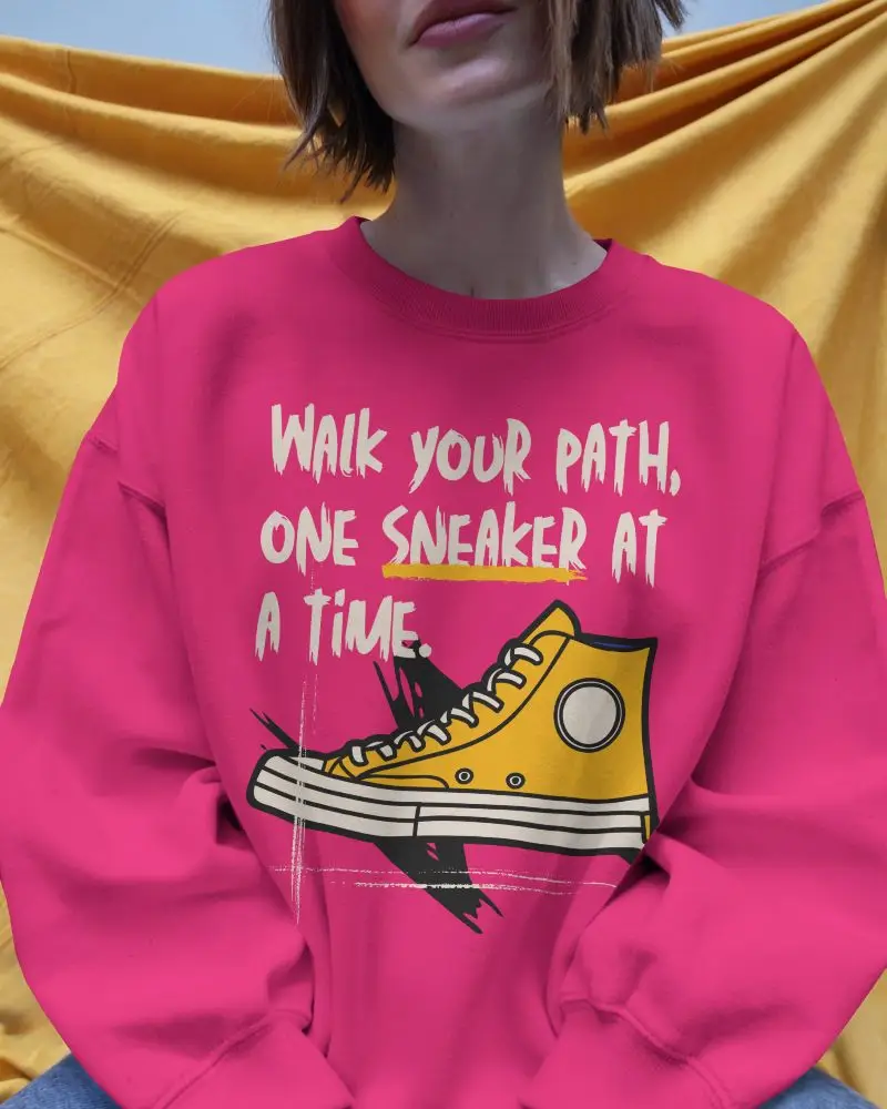 Blank White Sweatshirt Mockup Female Model Seated Front View With Yellow Fabric Background Casual Outfit For Design Showcase