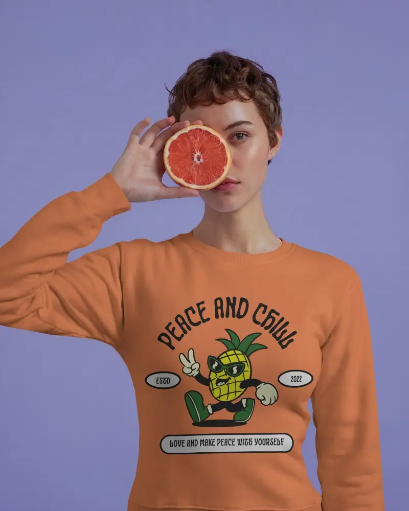 Playful White Sweatshirt Mockup Female Model Holding Grapefruit Against Purple Background Bold And Modern Style