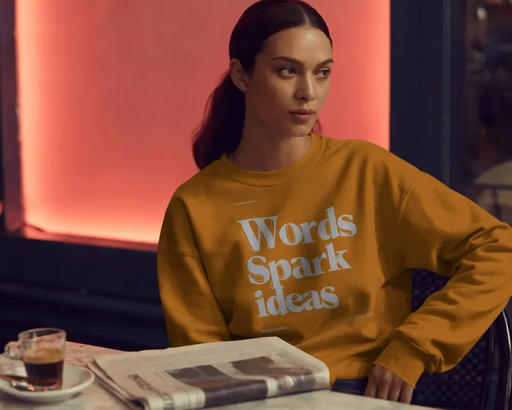 Cozy Cafe Sweatshirt Mockup Woman With Coffee Newspaper Warm Evening Light Fashion Look