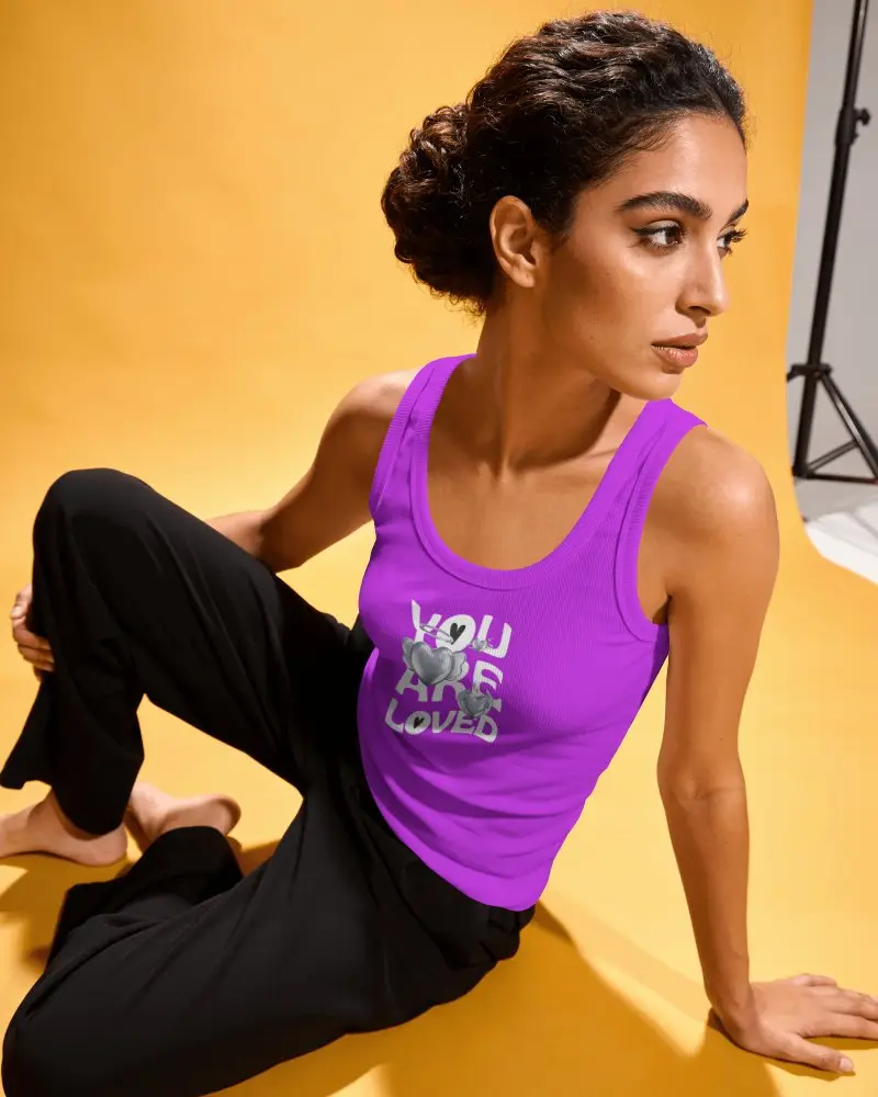 Seated Womens Tank Top Mockup With Curly Haired Model Leaning On One Arm And Looking Sideways