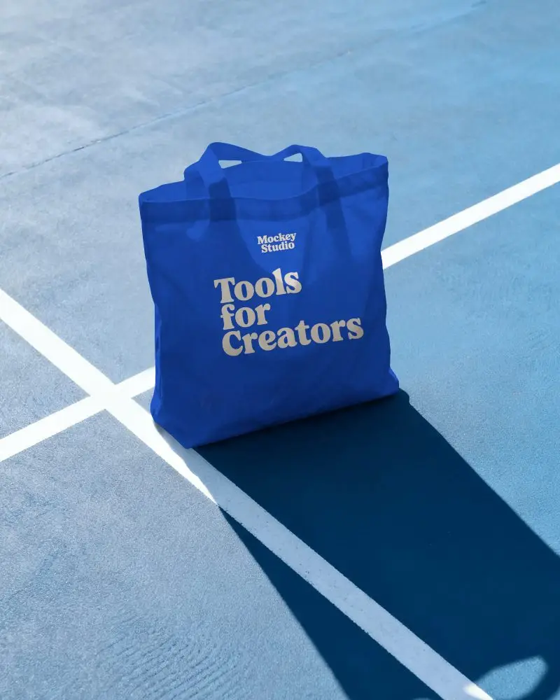 Tote Bag Mockup On Tennis Court Surface With Strong Sunlight And Shadow Lines
