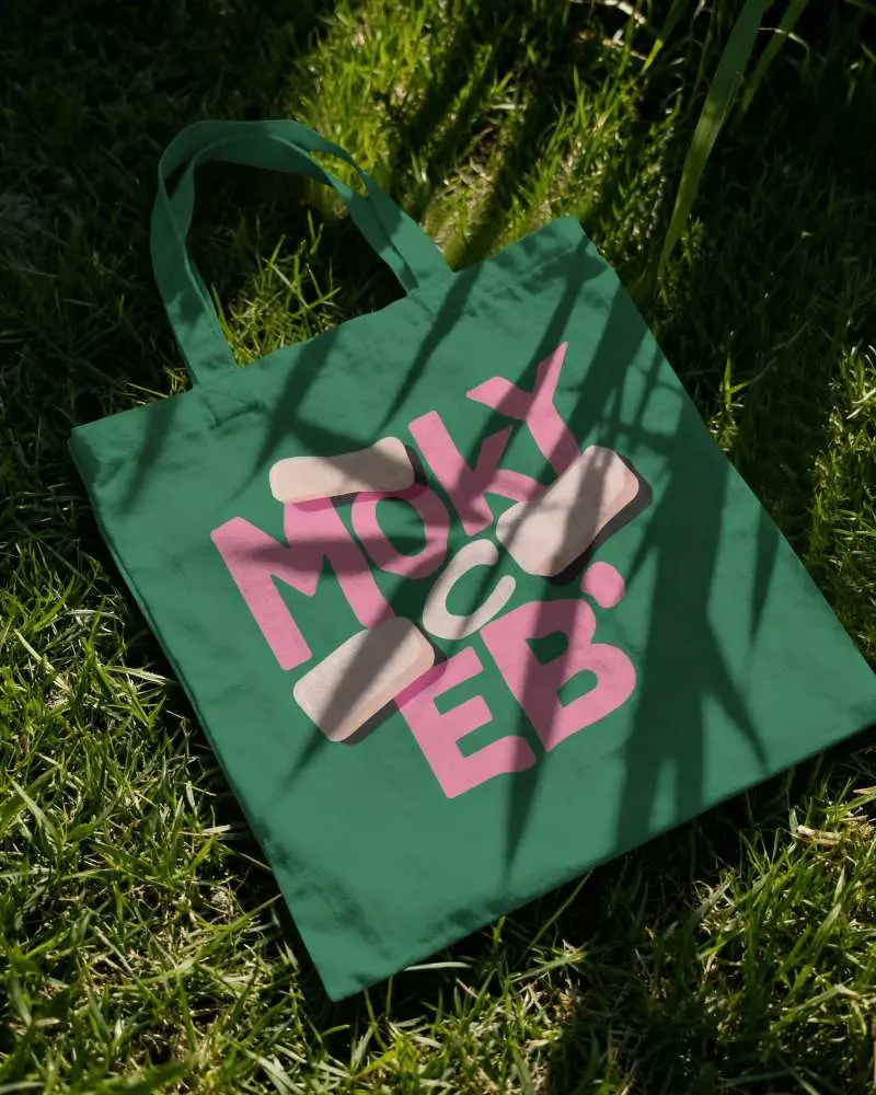 Tote Bag Mockup On Grass With Leaf Shadow Pattern And Natural Sunlight