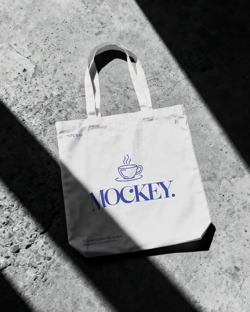 Eco Friendly Cotton Tote Bag Mockup With Long Handles On Textured Floor Background