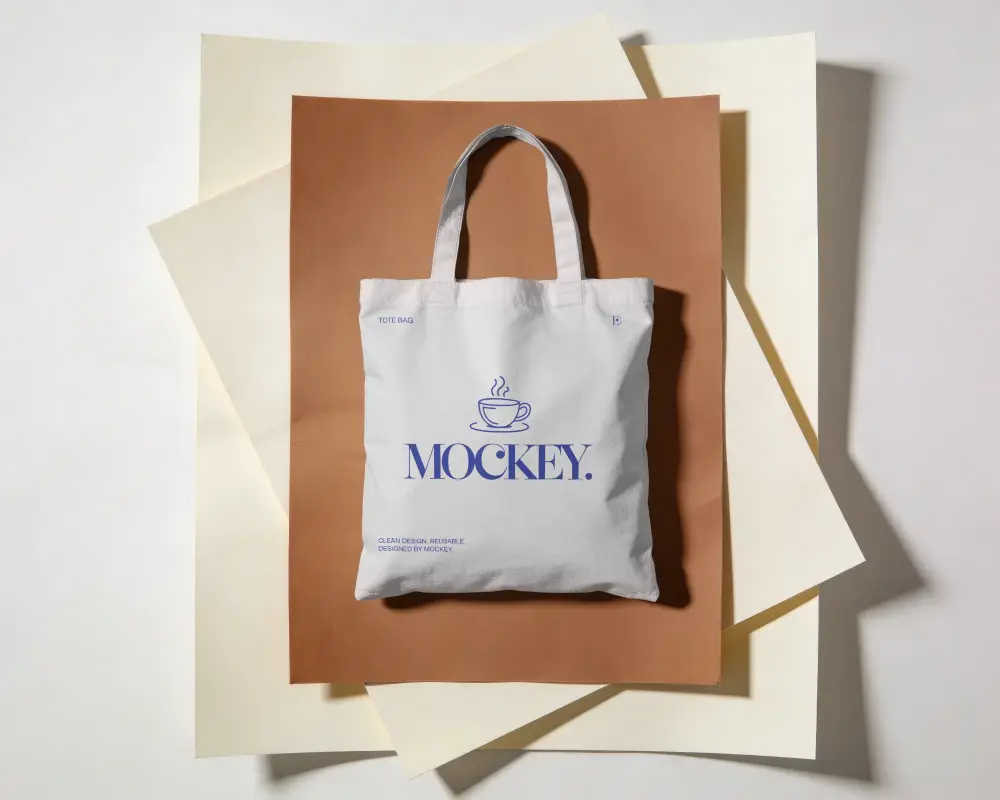 Eco Friendly Tote Bag Mockup On Layered Paper Texture For Fashion And Promotion Use