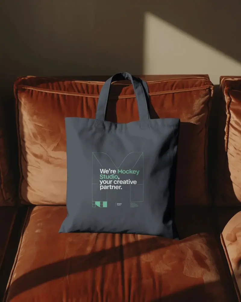 Cozy Living Room Tote Bag Mockup On Soft Velvet Couch Warm Sunlight Stylish Modern Home Decor