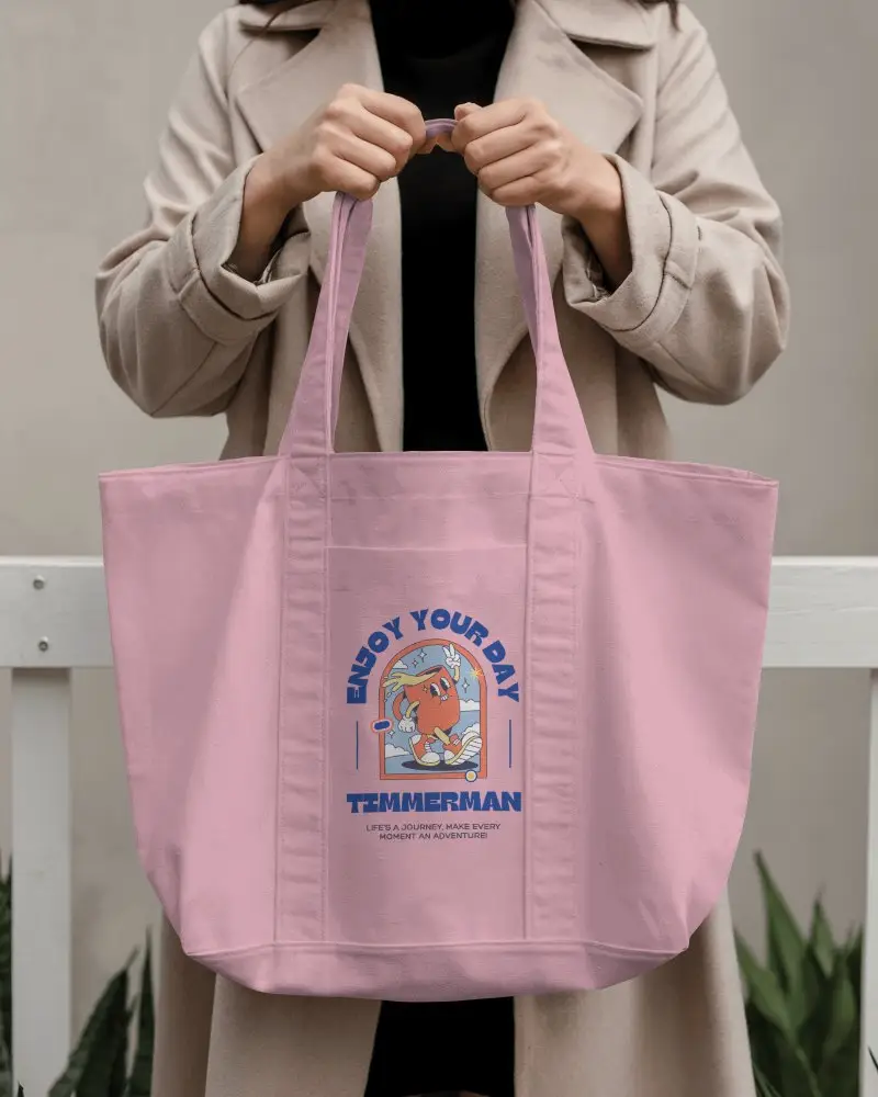 Totebag Mockup Front Facing Held With Both Hands By Standing Person Visible Coat Details Urban Outdoor Scene Confident Pose Functional Style