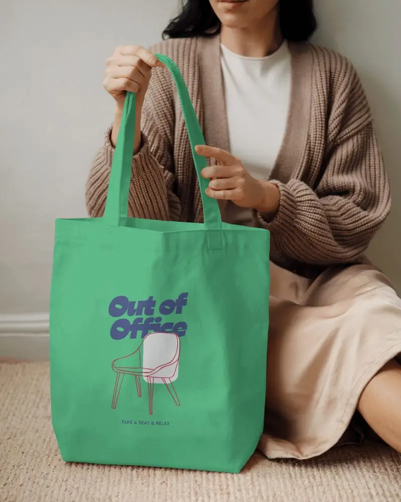 Totebag Mockup Seated Female Model Holding Handle With Both Hands Soft Indoor Lighting Cozy And Relaxed Atmosphere Casual Style