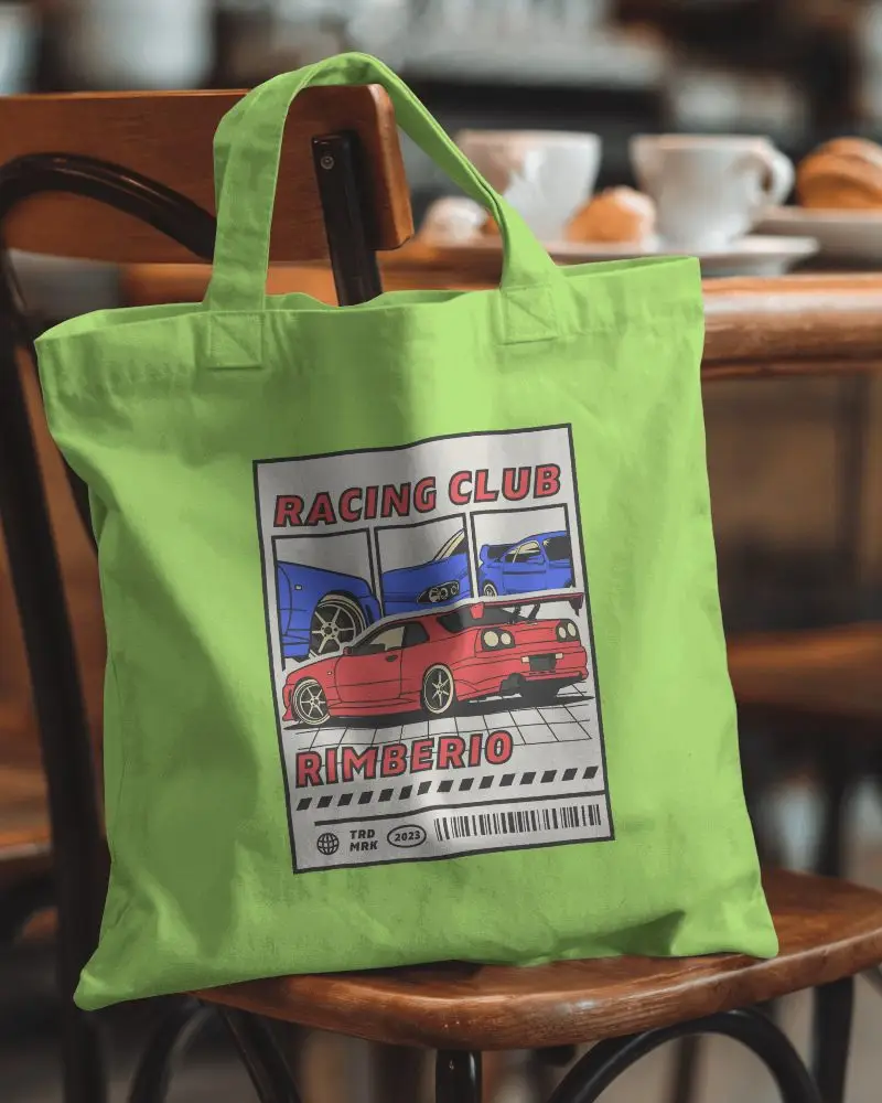 Cozy Cafe Totebag Mockup White Canvas Bag With Your Design Here Placeholder Hanging On A Warm Toned Wooden Chair In A Cozy Cafe Setting Relaxing And Inviting Vibe