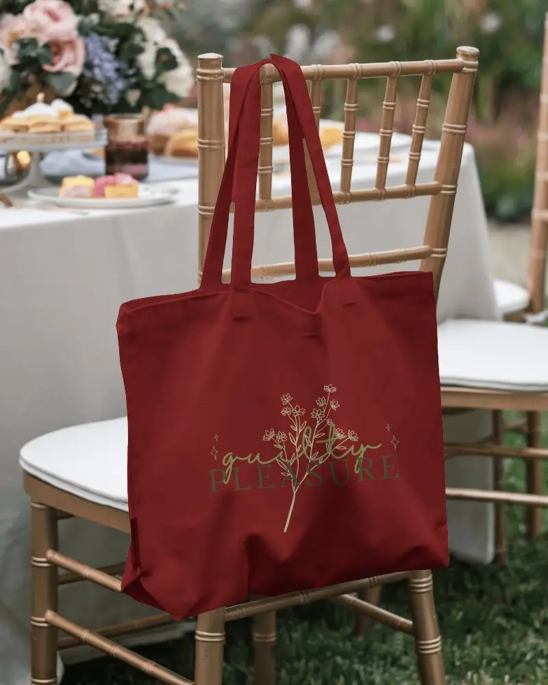 Event Branding Totebag Mockup Simple Tote Showcasing Design Zone In The Center Of A Curated Display On A Wicker Chair In Front Of A Table Set For A Special Occasion Retail and functional mood