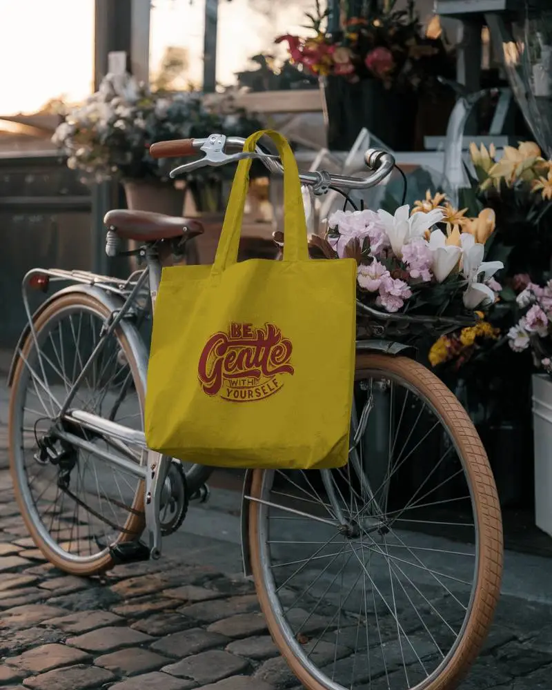 Charming Street Tote Bag Mockup Hanging On Vintage Bicycle Near Flower Shop At Golden Hour Romantic And Inviting