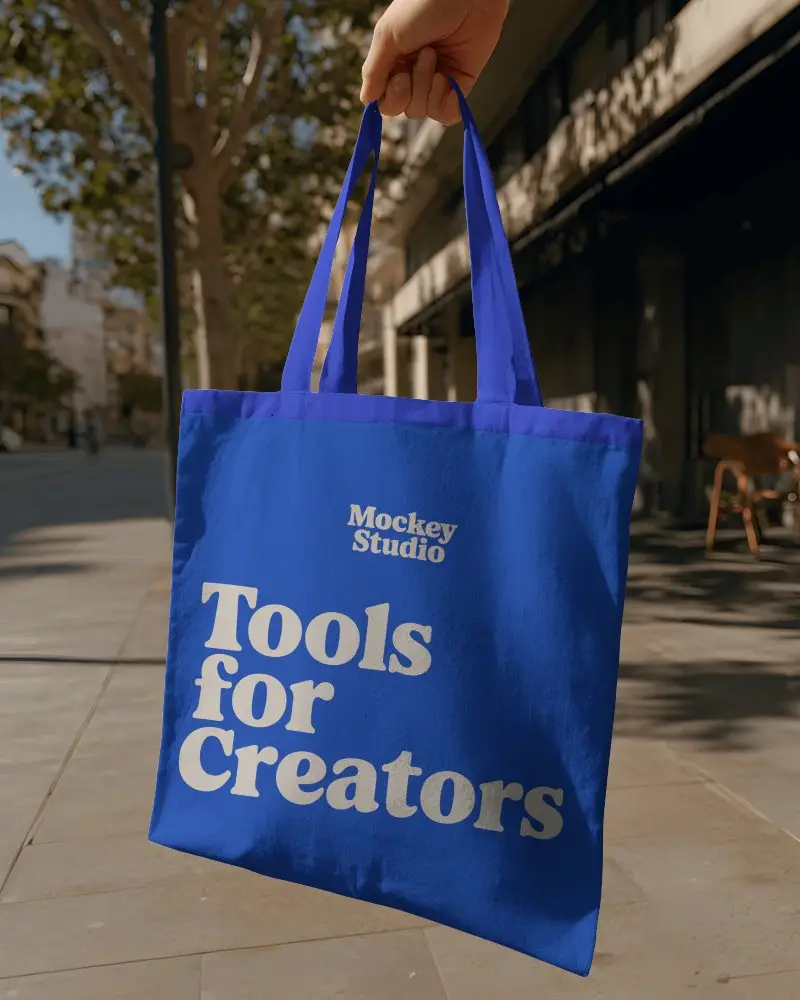 Durable Plain Tote Bag Mockup Hanging In Urban Setting For Brand Logo Showcasing Use