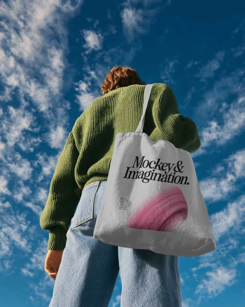 Low Angle Outdoor Totebag Mockup Back View Model Under Blue Sky With Natural Daylight