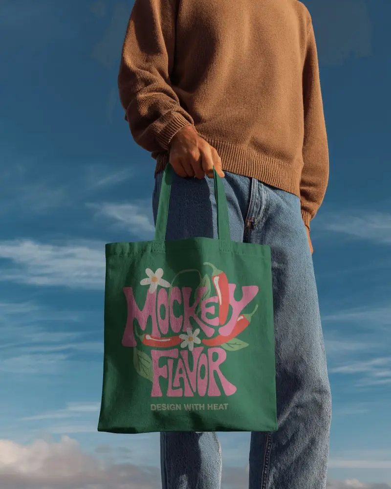 Handheld Outdoor Totebag Mockup With Casual Model Under Clear Blue Sky