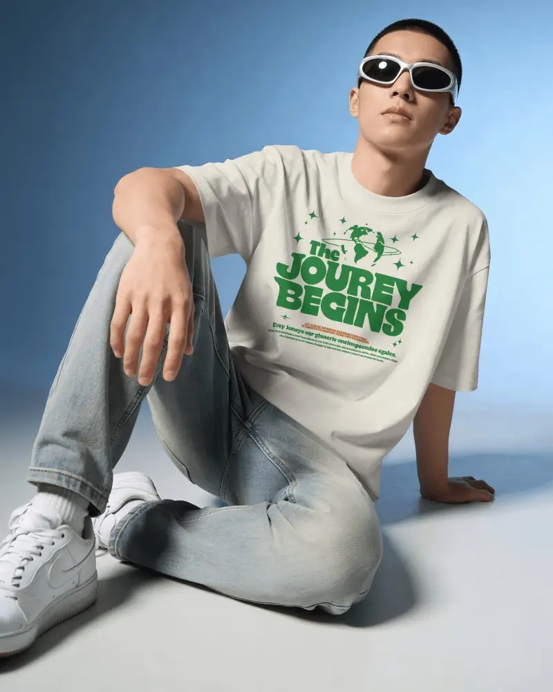 Cool Studio T Shirt Mockup Male Model Sitting On Floor Wearing Sunglasses Modern Minimal Background