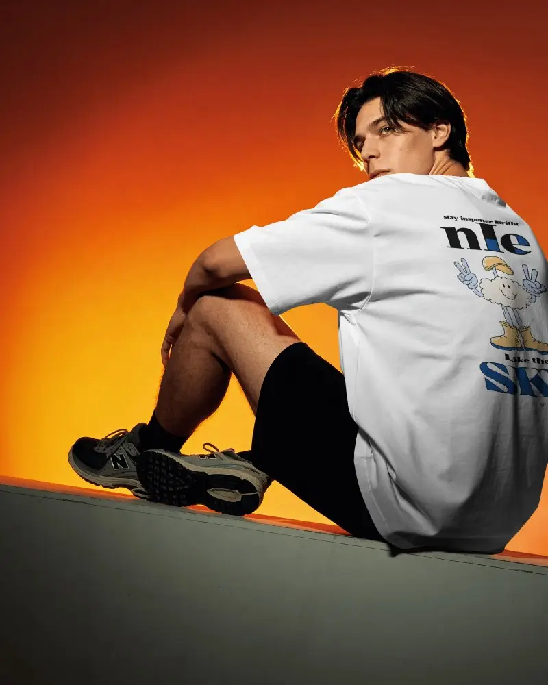 Sunset Gradient T Shirt Mockup Male Model Back Pose Looking Over Shoulder Dramatic Lighting