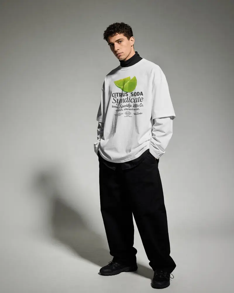 Layered Fashion T Shirt Mockup Male Model Standing Hands In Pockets Clean Studio Background