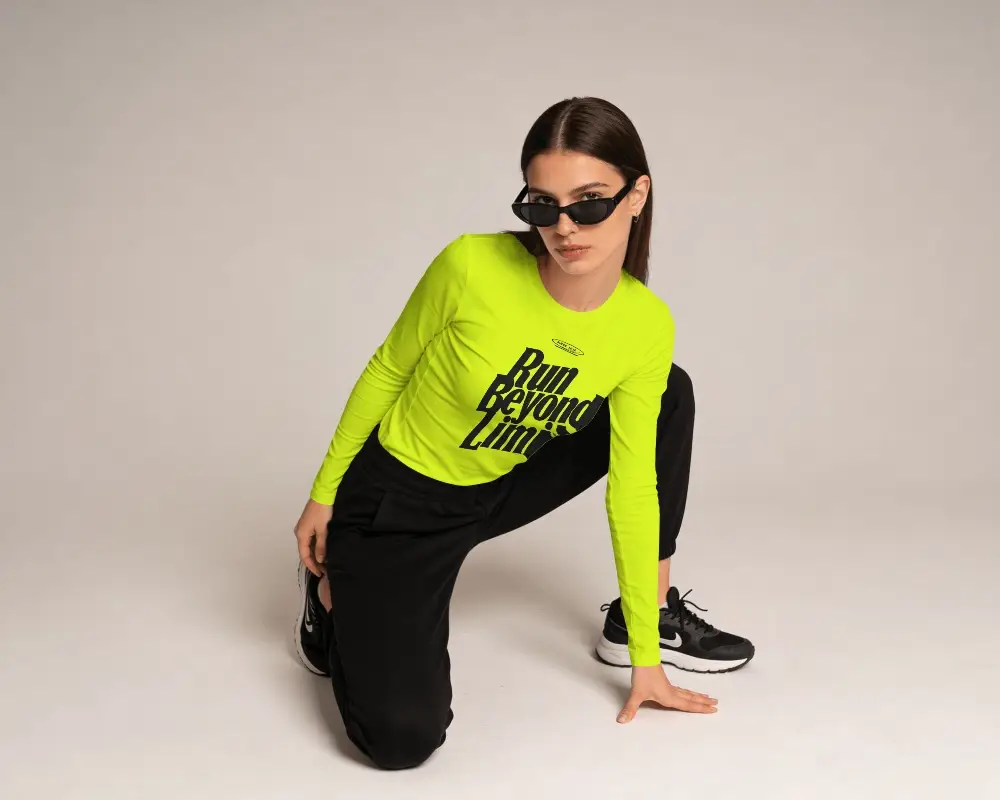 Fashion Long Sleeve T Shirt Mockup On Model With Kneeling Pose And Clean Studio Background