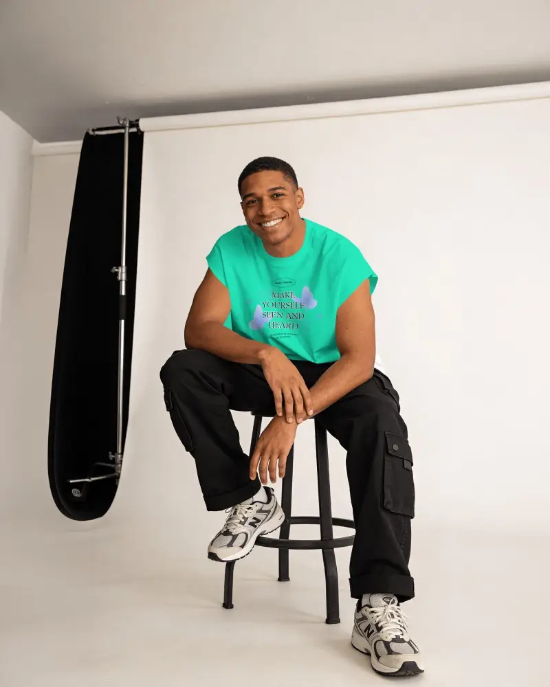 Studio High Stool T Shirt Mockup Male Model Relaxed Smile Clean Modern Studio Lighting