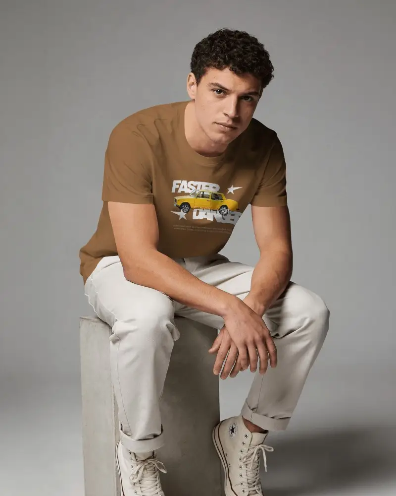 Seated Tshirt Mockup Male Model Leaning Forward On Studio Block With Modern Casual Styling