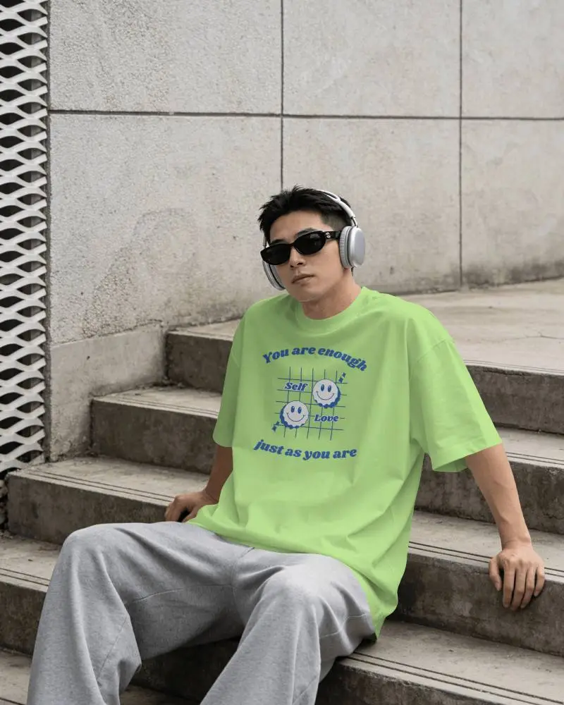 Printful Tshirt Mockup Male Model Sitting On Urban Steps Wearing Headphones In Streetwear Style
